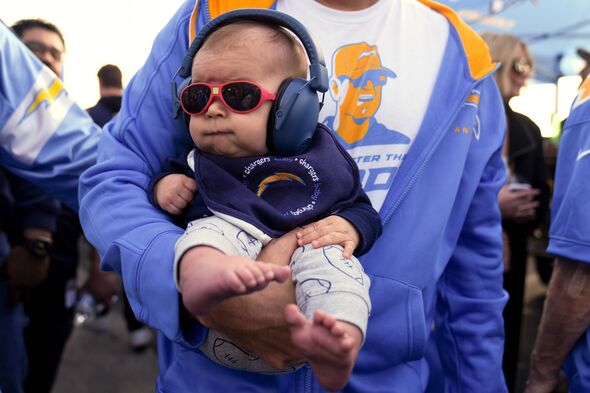 FILE - A baby is carried in the tailgating section 