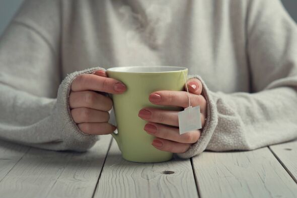 Woman's hands holding a cup of tea