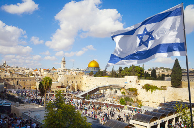 Israel flag with a view of old city Jerusalem and the Western Wall.