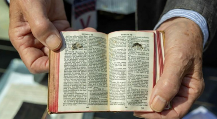 The original Bible of Lance Corporal Phillip Davies, a soldier during World War I, was shown at the new Bible launch event. It shows the damage caused by shrapnel likely to have killed Davies if the Bible had not been placed in a pocket shielding his heart.