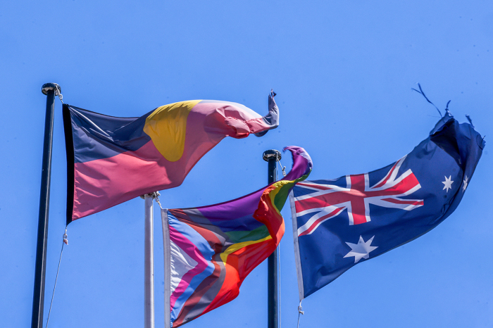 An Australian Aboriginal flag, a Pride flag and an Australian flag fly from a flag posts in Redfern on October 13, 2023, in Sydney, Australia.