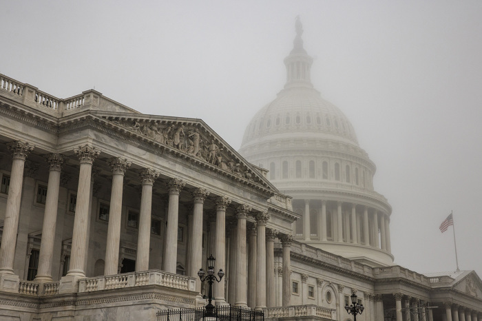 Early morning fog envelopes the U.S. Capitol dome behind the U.S. House of Representatives on Nov. 4, 2022, in Washington, D.C. Republicans are poised to regain control of the U.S. Congress in the midterm elections on Nov. 8 after the Democrats gained the majority in both the House in 2018 and Senate in 2020.