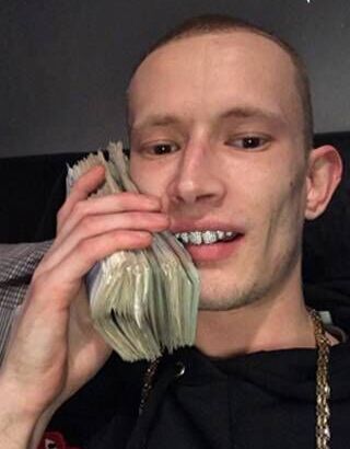 Damon Greenslade posing with wads of cash