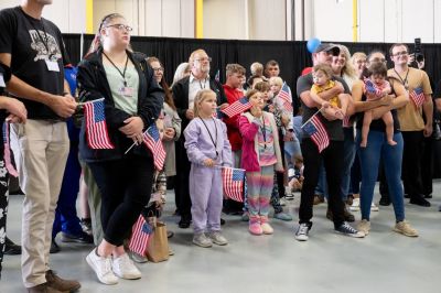 The first group of Afrikaners from South Africa to arrive for resettlement listen to remarks from U.S. Deputy Secretary of State Christopher Landau and U.S. Deputy Secretary of Homeland Security Troy Edgar after they arrived at Washington Dulles International Airport in Dulles, Virginia, on May 12, 2025.