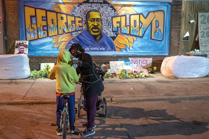 Shannon Haynes talks to her son, Ronald Haynes, 9, about George Floyd in front of a memorial following the verdict in the Derek Chauvin trial on April 20, 2021, in Minneapolis, Minnesota. The former Minneapolis police officer was found guilty today on all three charges he faced in the death of Floyd last May.