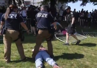 Police make an arrest during a May 24 rally at Cal Anderson Park organized by pro-life group Mayday USA as part of its '#DontMessWithOurKids' national tour, which drew hundreds of supporters and counter-demonstrators.