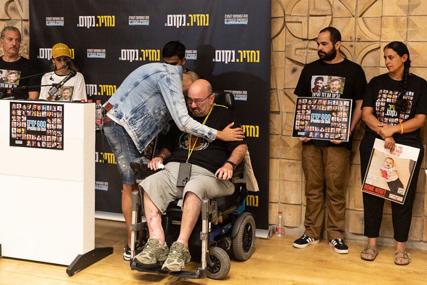 TEL AVIV, ISRAEL - MAY 28: Barak Oz, the cousin of hostage Tel Kupershtein, hugs Bar's father, Tal Kupershtein, during a press conference with former hostages and families of hostages 600 days after the deadly Oct 7 Hamas attack, on May 28, 2025 in Tel Aviv, Israel. The event was attended by former hostages who were taken captive by Hamas on Oct. 7, 2023, as well as family members of current hostages. It is believed Hamas still holds 58 hostages who were among the roughly 250 people originally taken captive. Israel has continued its retaliatory war against in Gaza, where at least 53,000 people have been killed, according to the territory's health ministry. (Photo by Amir Levy/Getty Images)