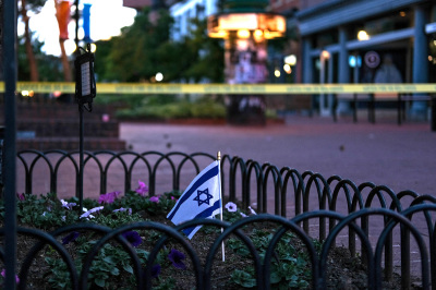 An Israeli flag stands in a bed of flowers as caution tape blocks off a deserted Pearl Street on the scene of an attack on demonstrators calling for the release of Israeli hostages held in Gaza, in Boulder, Colorado, on June 1, 2025. Several people suffered burns and other injuries in Colorado in what the FBI called a 'targeted terror attack' against demonstrators seeking the release of Israeli hostages held in Gaza. Police in the city of Boulder said a man was taken into custody. They were more cautious in presuming a possible motive for the attack, which multiple sources said was committed against members of the Jewish community during a peaceful gathering.