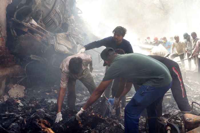 Rescue officials work at the site where Air India flight 171 crashed in a residential area near the airport in Ahmedabad on June 12, 2025. The London-bound passenger plane crashed on June 12 in India's western city of Ahmedabad with 242 on board, aviation officials said in what the airline called a 'tragic accident'. 
