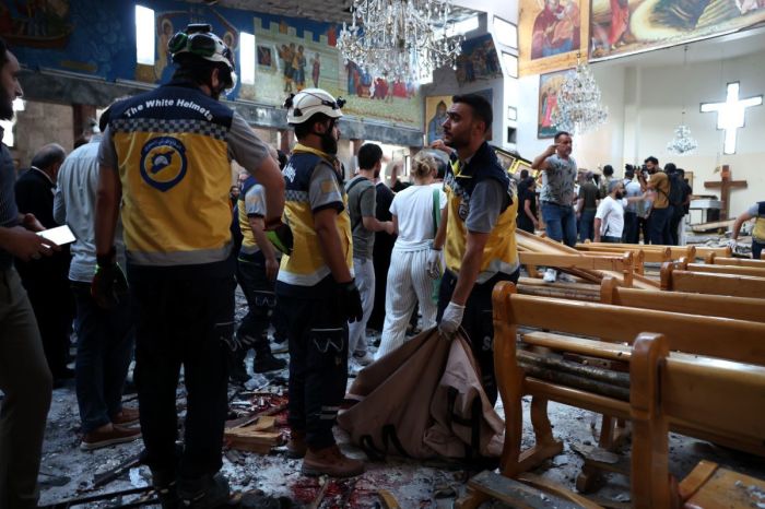 Emergency responders work at the site of a blast at the Mar Elias Church on June 22, 2025 in Damascus, Syria. A suspected suicide bombing has killed at least 20 people and injured 52 others who were attending a service at the Mar Elias Church in Damascus, according to Syria's Ministry of Health.