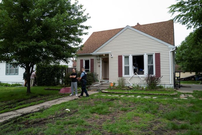 Vance Boelter's roommate, who declined to give his name, speaks with a Minneapolis police officer outside his home on June 14, 2025 in Minneapolis, Minnesota. Boelter a suspect in the shooting of two Democratic-Farmer-Labor lawmakers. DFL State Rep. Melissa Hortman and her husband, Mark Hortman, were shot and killed this morning. DFL State Sen. John Hoffman and his wife were also shot and hospitalized in a separate incident. Minnesota Gov. Tim Walz said during a press conference that the shooting 'appears to be a politically motivated assassination.'