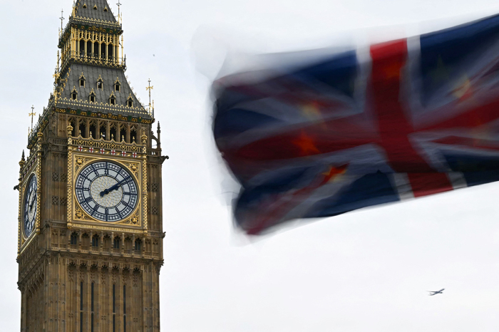 A photograph taken on Jan. 31, 2024, shows a Union Jack flag with behind a a European Union flag flapping in the air in front of 'Big Ben' in London, England.