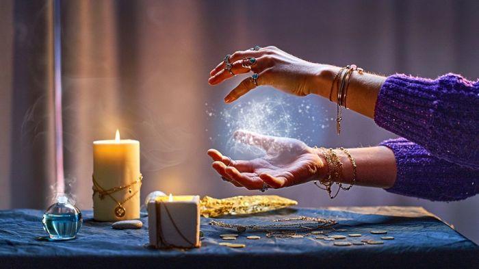 Magical luminous swirling glowing ball in the palm of a witch wizard woman during a witchcraft and occult esoteric spiritual ritual. 