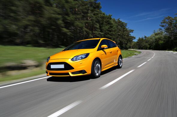 Generic yellow sports car driving fast on the road