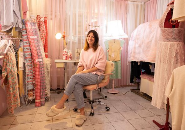 Truly Sopel sits next to her sewing machine