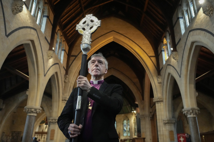 Archbishop of Wales Andrew John poses with the Cross of Wales ahead of the blessing of the cross at Holy Trinity Church, Llandudno on April 19, 2023, in Llandudno, Wales. The Cross of Wales, is a new processional cross presented by His Majesty King Charles III as a centenary gift to the Church in Wales and will lead the Coronation procession at Westminster Abbey on 6 May. Words from the last sermon of St. David are chased on the back of the Cross in Welsh: “Byddwch lawen. Cadwch y ffydd. Gwnewch y Pethau Bychain,' which translates as: “Be joyful. Keep the faith. Do the little things.” The cross was designed and made by master silversmith Michael Lloyd.