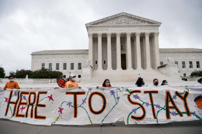 Activists hold a banner in front of the US Supreme Court in Washington, DC, on June 18, 2020. The U.S. Supreme Court rejected President Donald Trump's move to rescind the DACA program that offers protections to 700,000 undocumented migrants brought to the US as children.