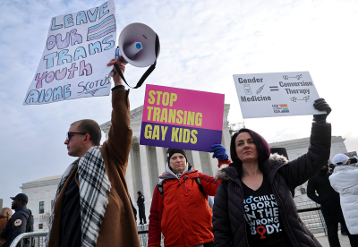 Trans activists, opponents and a supporter rally outside of the U.S. Supreme Court as the justices hear arguments in U.S. v. Skrmetti, a case about Tennessee's law banning puberty blockers, cross-sex hormones and body-mutilating surgeries for minors and whether it violates the Constitution’s equal protection guarantee on Dec. 04, 2024, in Washington, D.C.