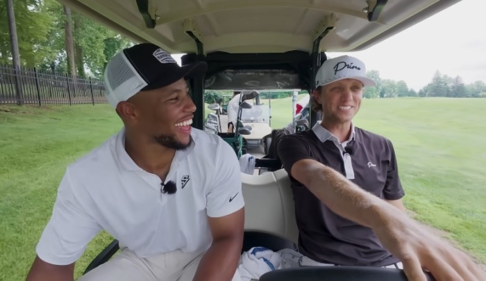 Saquan Barkley (left) rides in a golf cart with golfer Grant Horvat in a video posted to YouTube on June 25, 2025.