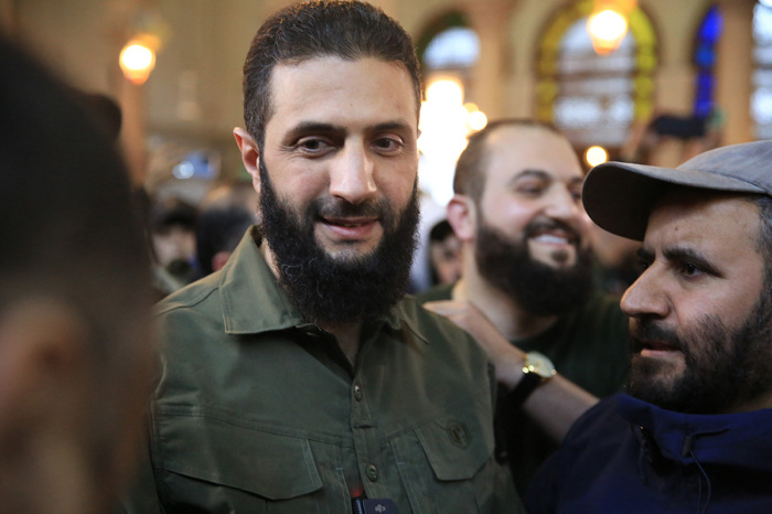 Supporters welcome the leader of Syria's Islamist Hayat Tahrir al-Sham (HTS) group that headed a lightning rebel offensive snatching Damascus from government control, Abu Mohammed al-Jolani (C), before his address at the capital's landmark Umayyad Mosque on December 8, 2024. Jolani, now using his real name Ahmed al-Sharaa, gave a speech as the crowd chanted 'Allahu akbar (Allah is greatest),' a video shared by the rebels on their Telegram channel showed.