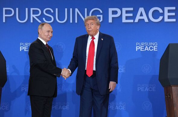Donald Trump and Vladimir Putin shake hands 