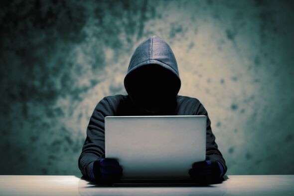 Computer Hacker Holding Laptop
