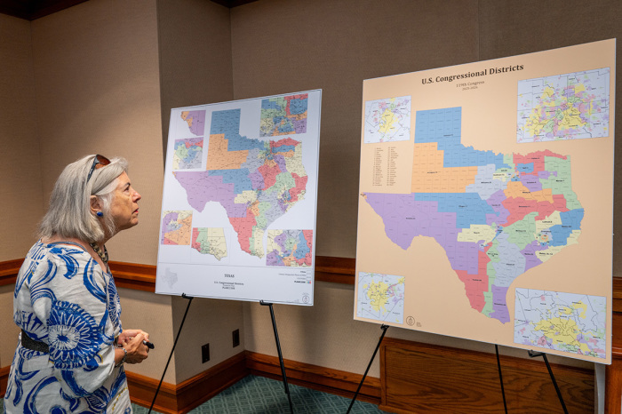 A person, who declined to be named, views a U.S. Congressional District map as the Senate Special Committee on Congressional Redistricting meets to hear invited testimony on Congressional plan C2308 at the Texas State Capitol on Aug. 6, 2025, in Austin, Texas. The meeting adjourned early due to a lack of attendees for testimony. Earlier this week, Texas Democratic lawmakers fled the state in an attempt to protest and deny quorum for votes on the proposed Republican redistricting plan, which would secure five additional GOP seats in the U.S. House. Gov. Greg Abbott has threatened to remove lawmakers who do not return and has asked the Texas Supreme Court to expel House Democratic leaders who fled the state.