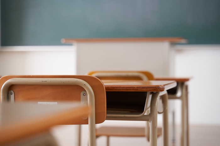 Desks lined up in a classroom.