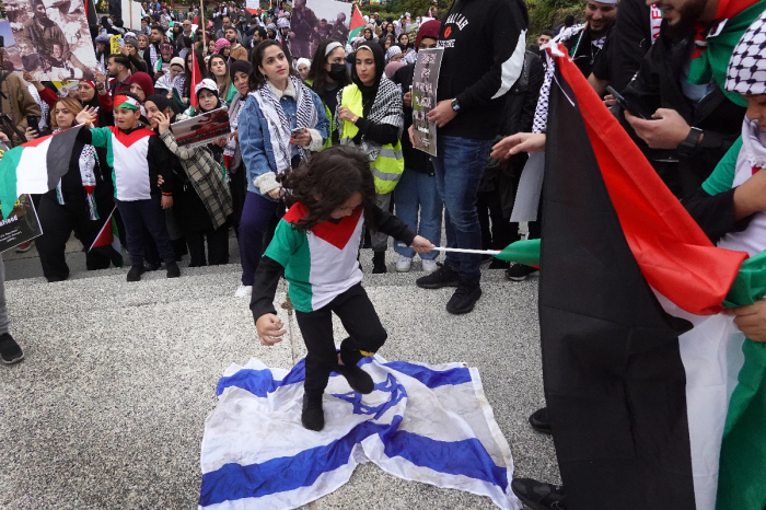 A child stomps on an Israeli flag during a demonstration in Chicago, Illinois, to show support for the Palestinian people on October 11, 2023. Rally marshals stopped the display and attempted to take the flag. Organizers of the event called on the U.S. government to stop supporting Israel, which they refer to as a 