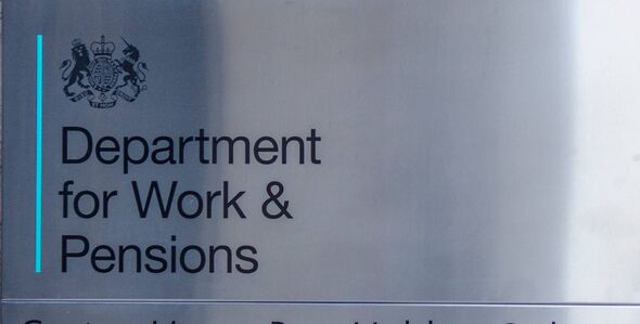 Exterior signage of UK government building with people walking past