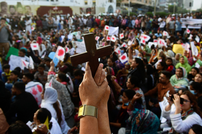 Christians hold the holy cross during a protest in Karachi on Aug.19, 2023, to condemn the attacks on churches in Pakistan. More than 80 Christian homes and 19 churches in Pakistan were vandalized when a Muslim mob rampaged through the streets over alleged blasphemy on Aug. 16, a top police official said on Aug.18.