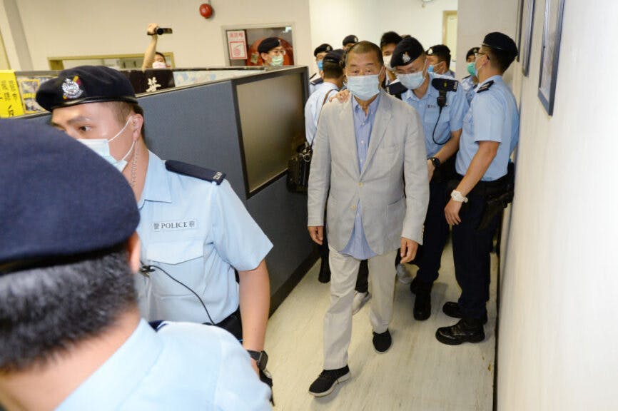 HONG KONG, CHINA - AUGUST 10: A handout photo from Apple Daily showing Hong Kong business tycoon Jimmy Lai led by police officers during a search at the headquarters of Apple Daily after Lai, was arrested at his home on August 10, 2020 in Hong Kong, China. Hong Kong police arrested seven people, including business tycoon Jimmy Lai on Monday on charges of violating the territory's new national security law. Police officers raided the pro-democracy newspapers headquarter while leading Mr. Lai and the company's chief executive, Cheung Kim-hung, through the offices in handcuffs. (Photo by Handout/Getty Images)