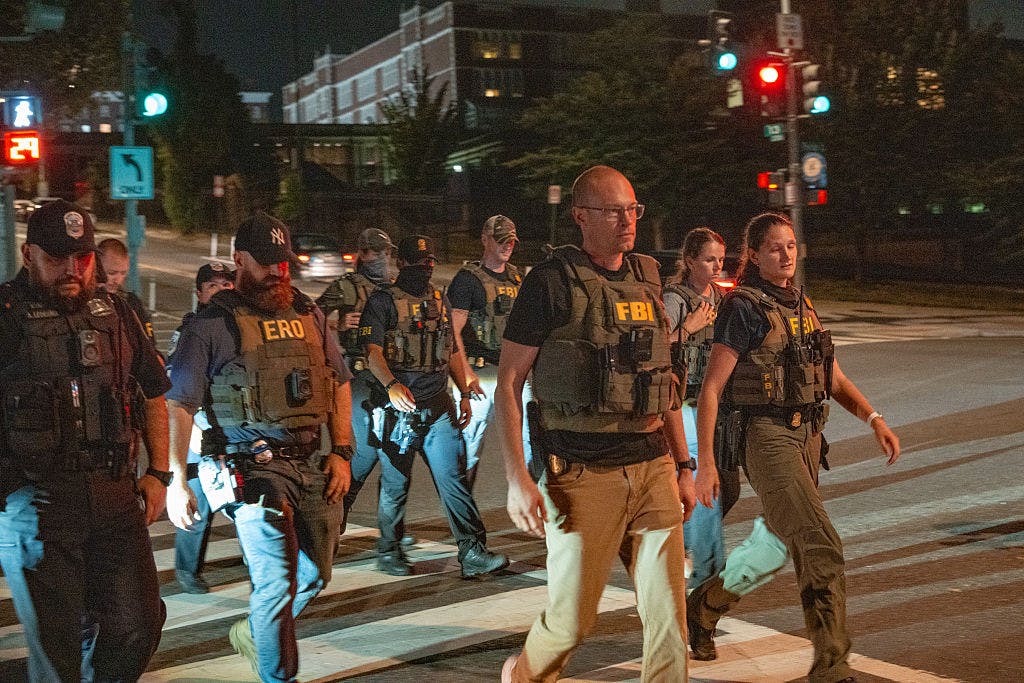 WASHINGTON, DC - AUGUST 13: FBI agents walk on patrol in the U street neighborhood on August 13, 2025 in Washington, DC. U.S. President Donald Trump announced plans to deploy federal officers and the National Guard to the District in order to place the DC Metropolitan Police Department under federal control and assist in crime prevention in the nation's capital.