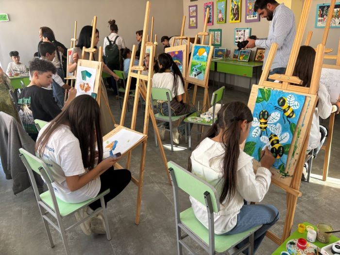 Students work on paintings at the Community and Family nonprofit therapy center in Metsamor, Armenia, on Sept. 25, 2025.