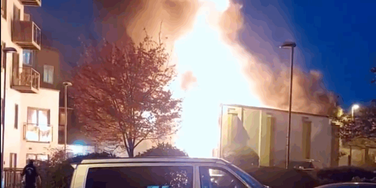 100 firefighters rush to scene as property engulfed in flames