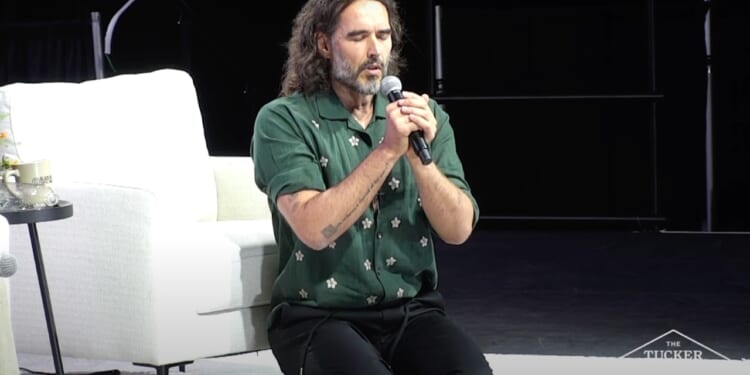 Russell Brand prays in Jesus' name at TPUSA event