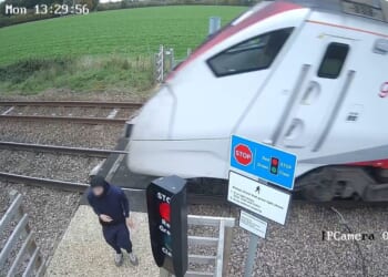 Watch gobsmacking moment teen CHEATS DEATH as he plays 'deadly game' next to 100mph train tracks