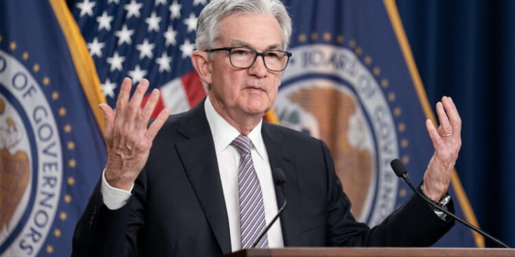 A divided Federal Reserve cuts interest rates by a quarter of a point