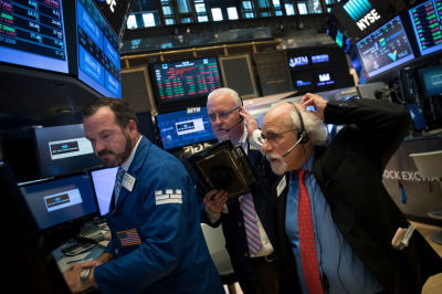 Traders and financial professionals work on the floor of the New York Stock Exchange (NYSE) ahead of the closing bell, July 18, 2017 in New York City. While the Nasdaq and S&P 500 hit record highs on Tuesday, the Dow Jones Industrial Average was down over 50 points.