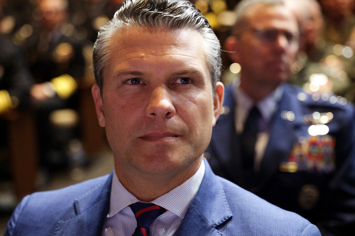 U.S. Secretary of War Pete Hegseth listens as U.S. President Donald Trump speaks to senior military members at Marine Corps Base Quantico on Sept. 30, 2025, in Quantico, Virginia. In an unprecedented gathering, almost 800 generals, admirals and their senior enlisted leaders have been ordered into one location from around the world on short notice.