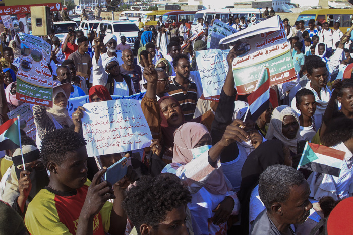 People lift placards as they chant during a rally called for by Sudan's Popular Front for Liberation and Justice in Port Sudan on April 24, 2025, to denounce the siege imposed by the paramilitary Rapid Support Forces (RSF) on El-Fasher city and express support for its residents. Since April 2023, the war between the army and the RSF has killed tens of thousands, uprooted 13 million and created what the U.N. describes as the world's worst humanitarian crisis. El-Fasher, the state capital of North Darfur, remains the last major city in the vast Darfur region that the paramilitary group has not conquered.