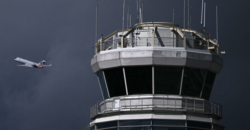 An airliner takes off near the control tower at Ronald Reagan Washington National Airport in Arlington, Virginia, on Wednesday.