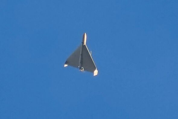 FILE - An Iranian Shahed exploding drone launched by Russia flies through the sky seconds before it struck buildings in Kyiv, Uk