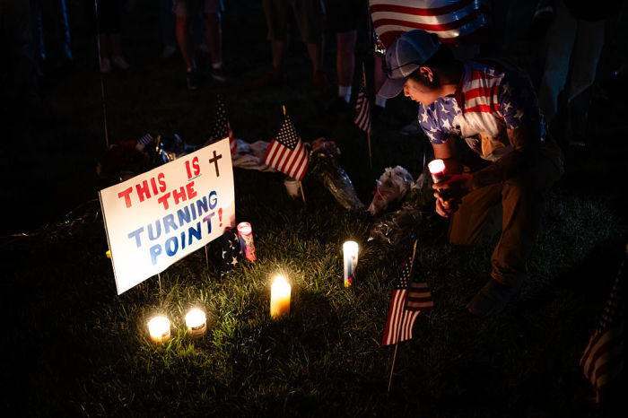 A person holds a candle in the memorial space during a Charlie Kirk vigil at Burlington Commons on September 17, 2025 in Burlington, Kentucky. Kirk, the CEO and co-founder of Turning Point USA, was shot and killed on September 10 while speaking at an event for his