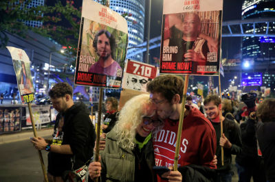 People react to the reports of a possible Gaza cease fire and hostage release deal being reached during a rally calling for the return of hostages held in the Gaza Strip on January 15, 2025 in Tel Aviv, Israel. A ceasefire deal between Israel and Hamas was announced tonight that would entail the release of Israeli hostages held in Gaza, according to officials from Hamas, the United States, and other parties. (