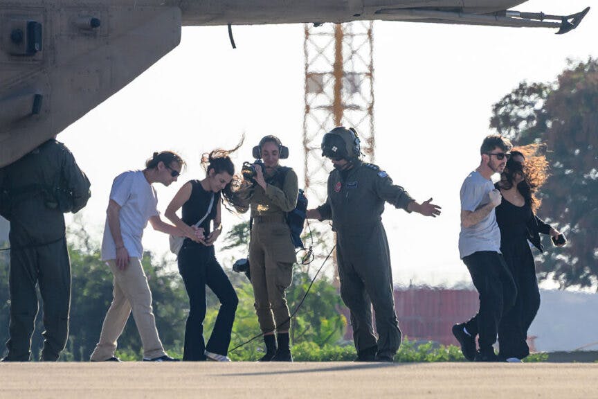 RAMAT GAN, ISRAEL - OCTOBER 13: Released hostage David Cunio (2L) walks with his wife, former hostage, Sharon Aloni-Cunio (L) in front of his brother, released hostage, Ariel Cunio(R), and his partner, former hostage Hostage survivor Arbel Yahud (C-R), after arriving at Chaim Sheba Medical Center at Tel HaShomer on October 13, 2025 in Ramat Gan, Israel. The ceasefire deal between Israel and Hamas has brought an end to the two years of war that followed the attacks of Oct. 7, 2023. A condition of the deal was the immediate return of 48 hostages held in Gaza, around 20 of whom were believed to be alive. (Photo by Alexi J. Rosenfeld/Getty Images)