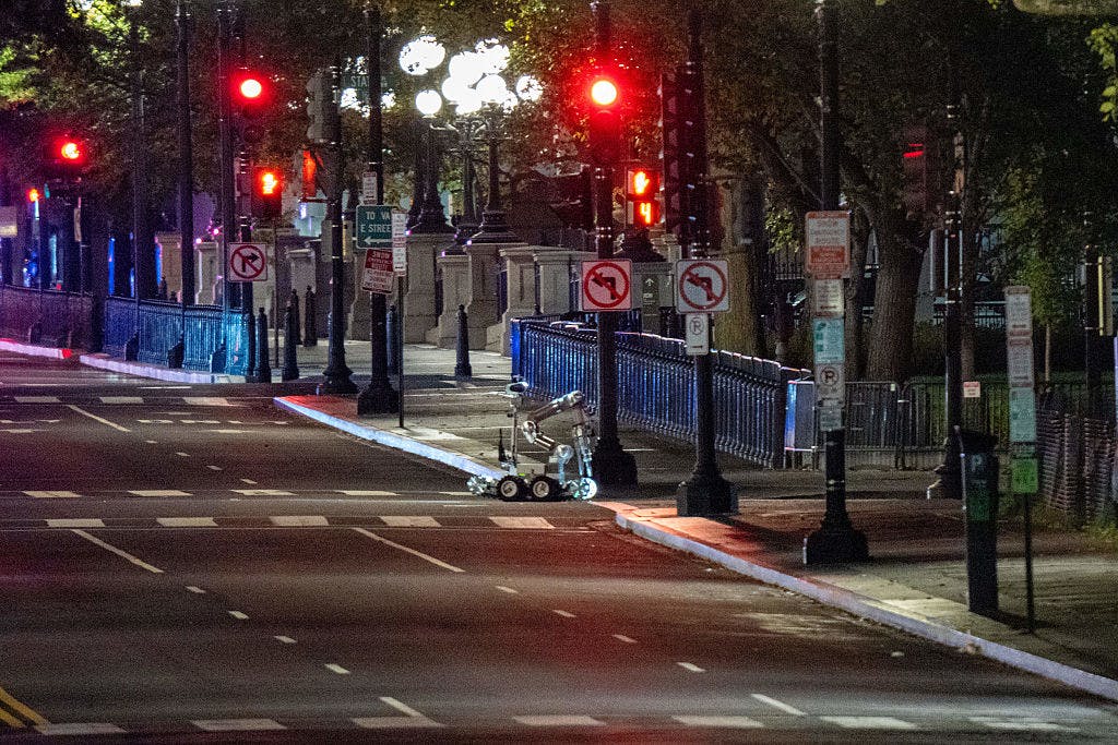 WASHINGTON, DC - OCTOBER 21: A bomb detection robot inspects the scene after a vehicle rammed a security barricade at the White House complex on October 21, 2025 in Washington, DC. The Secret Service reported that one individual was arrested and that the vehicle is now deemed safe.