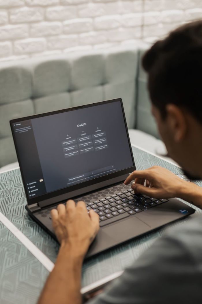 A person typing on a laptop.