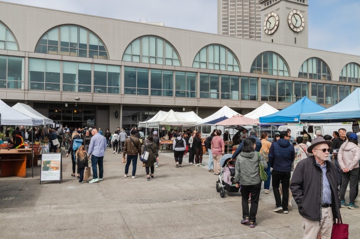 People watch during the thrice-weekly farmers market at the Ferry Building in San Francisco.