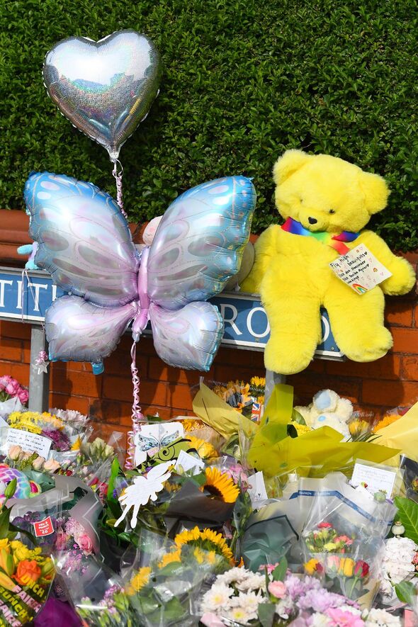 A yellow teddy bear,with the floral tributes on Hart Street,Southport.